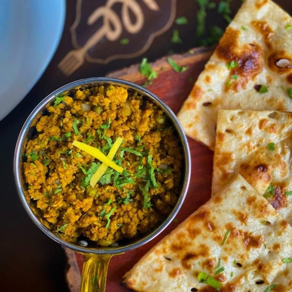 Aman's Artisan Indian Cuisine's keema matar, a minced meat curry, served with naan bread.