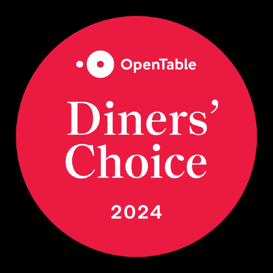 A red circular OpenTable Diners' Choice 2024 award logo for Aman's Artisan Indian Cuisine.